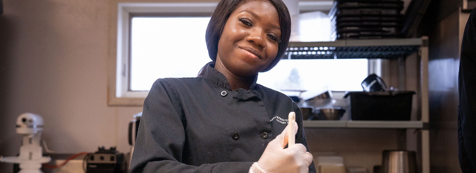 Culinary student Momore Olorunfemi stirs ingredients.
