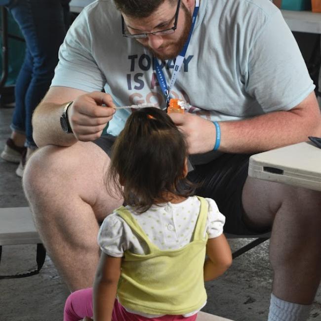 Corey Evans blows bubbles with a patient during his medical mission in Nicaragua