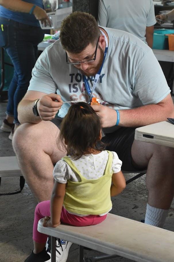 Corey Evans blows bubbles with a patient during his medical mission in Nicaragua