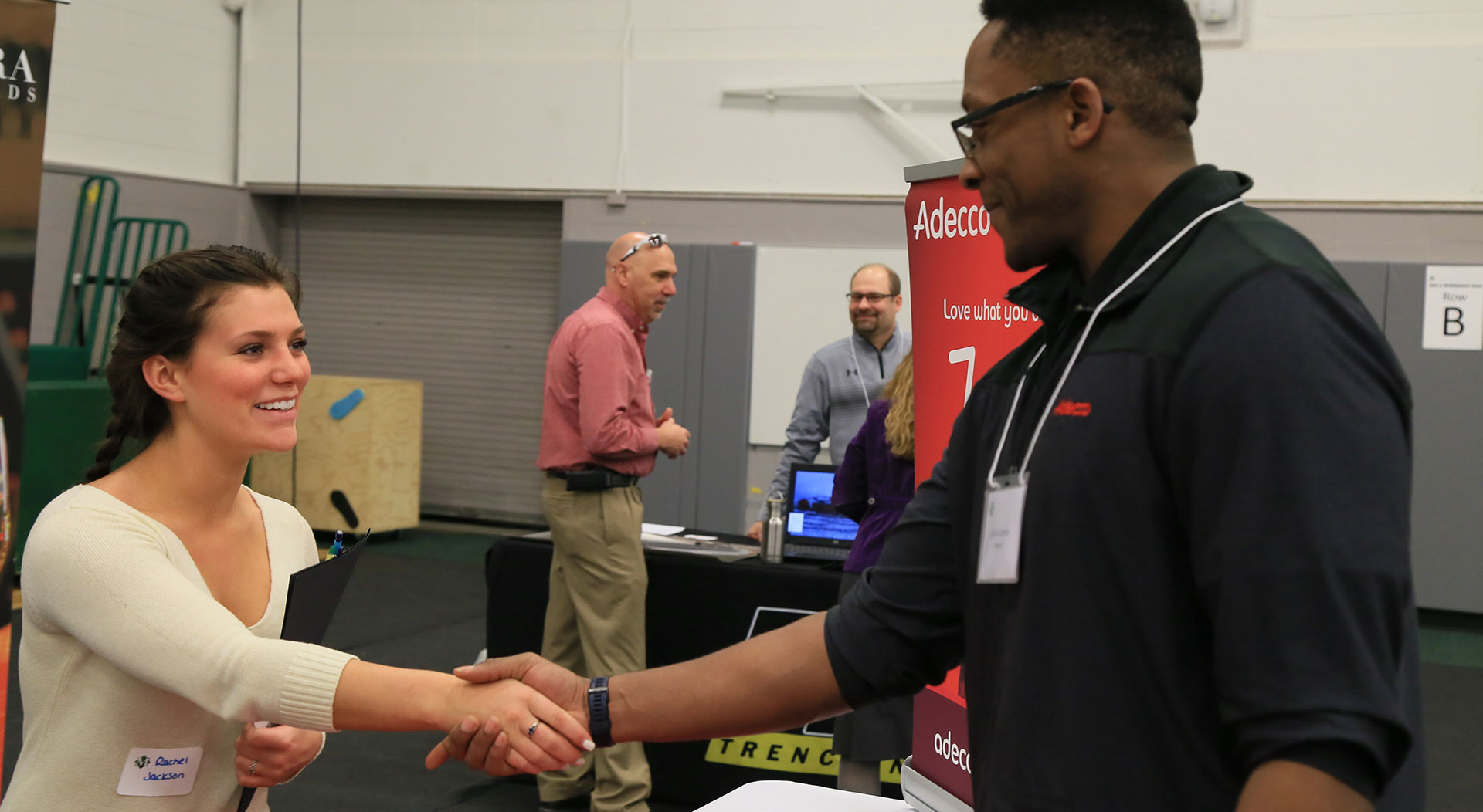 A student and employer shake hands at a past SUNY Morrisville job fair.