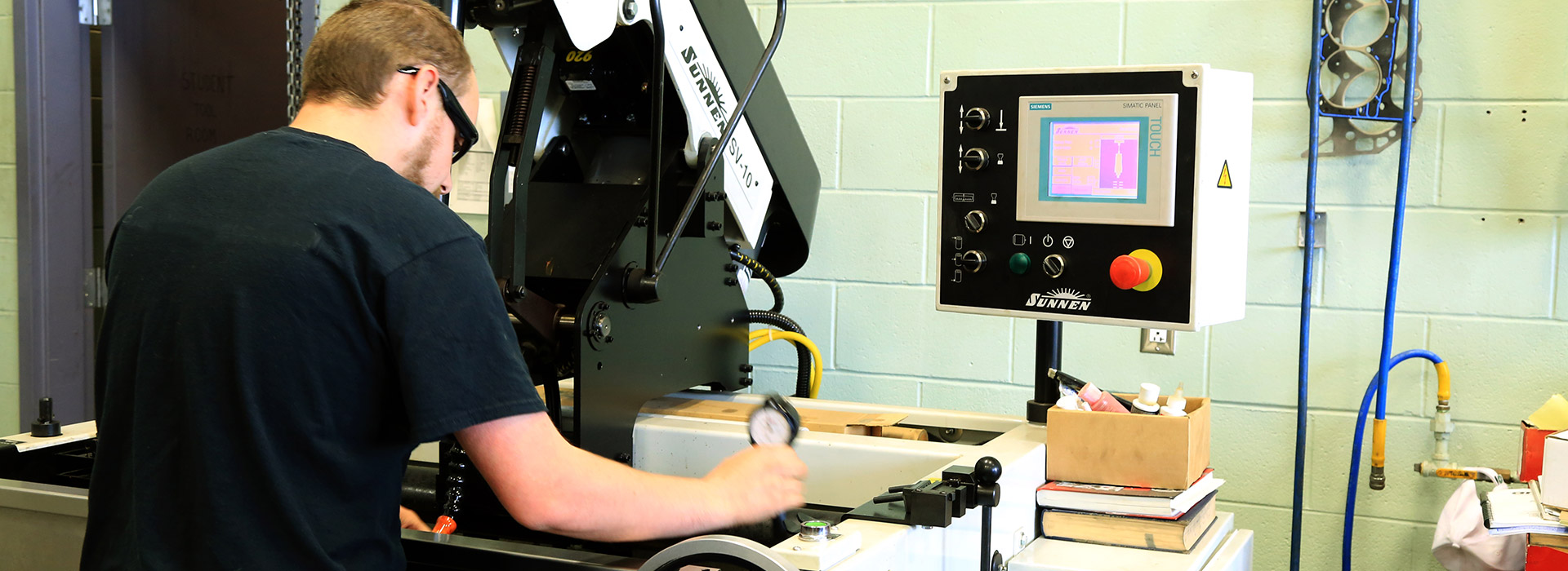 a student uses manufacturing equipment