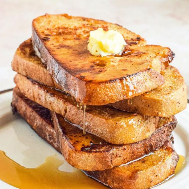 Stack of French toast with butter and syrup