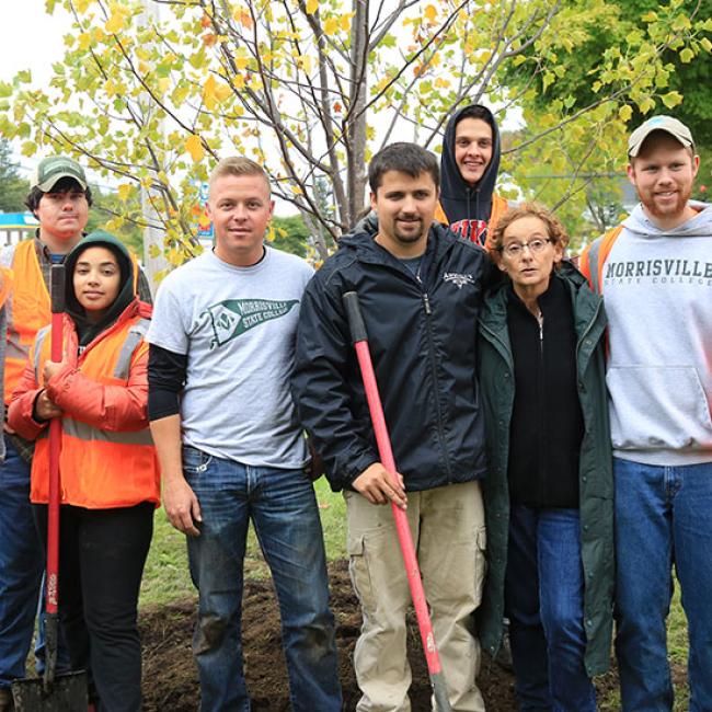 group of students partaking in tree planting