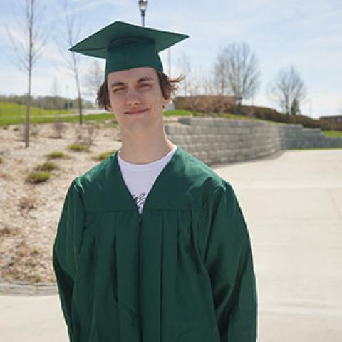 Recent graduate, Malcom Ivers, in his commencement regalia