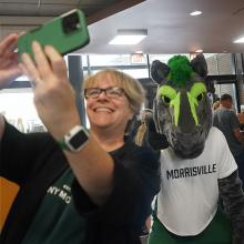 Dr. Grau poses for a selfie with mascot Mo